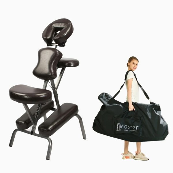 A woman carrying the folded Master Massage Bedford chair inside its black carrying case with shoulder strap.