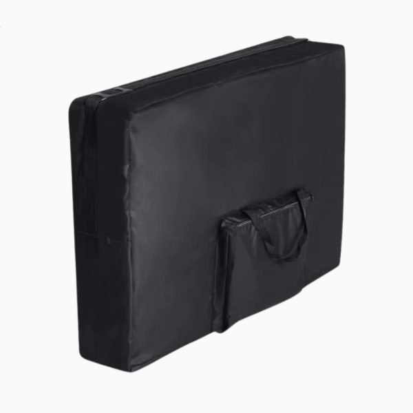 A black folded portable massage table inside its durable carrying case. The case has a padded top edge for comfort and a large side pocket for storage, viewed from a three-quarter perspective against a white background.