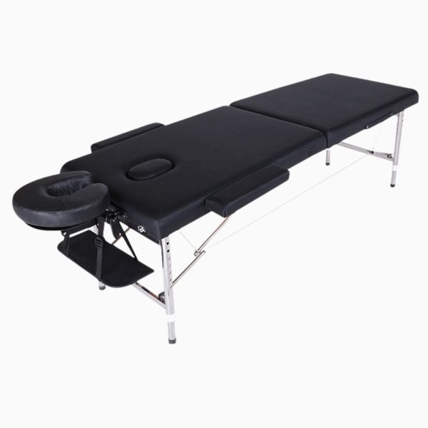 An unfolded 2-section black vinyl portable massage table with a sturdy, polished stainless steel frame. Features include a removable U-shaped face cushion, a hanging arm shelf, and removable padded side armrests, shown in an elevated three-quarter view.