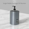 Professional Single Bottle Massage Oil Warmer on a white marble countertop with subtle steam rising from the pump.