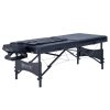 A professional studio shot of a black, portable, adjustable-height massage table featuring an integrated airbag stretching system and an adjustable headrest.