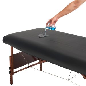 Liquid poured onto a water-resistant black PU vinyl massage table cover.