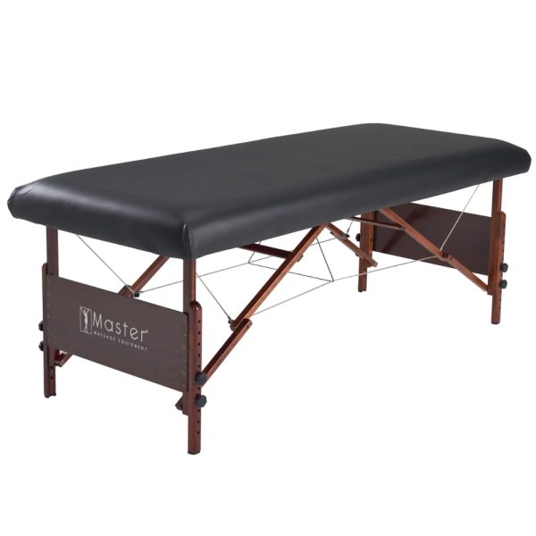 Black Master Massage universal fitted PU vinyl leather cover installed on a wooden table.